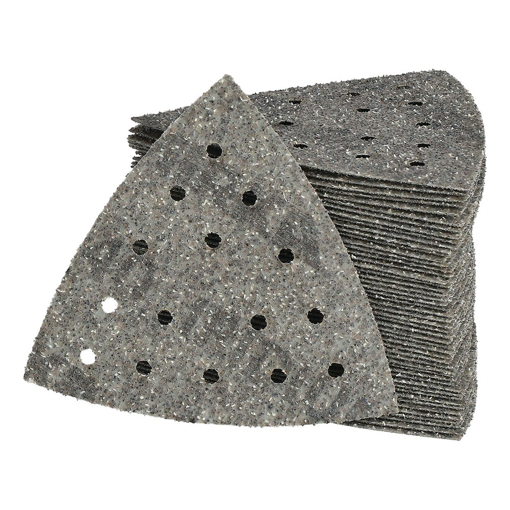 A stack of perforated triangular sanding sheets, with one sheet placed