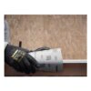 A gloved hand holds a sheet of sanding paper with Mirka markings, against