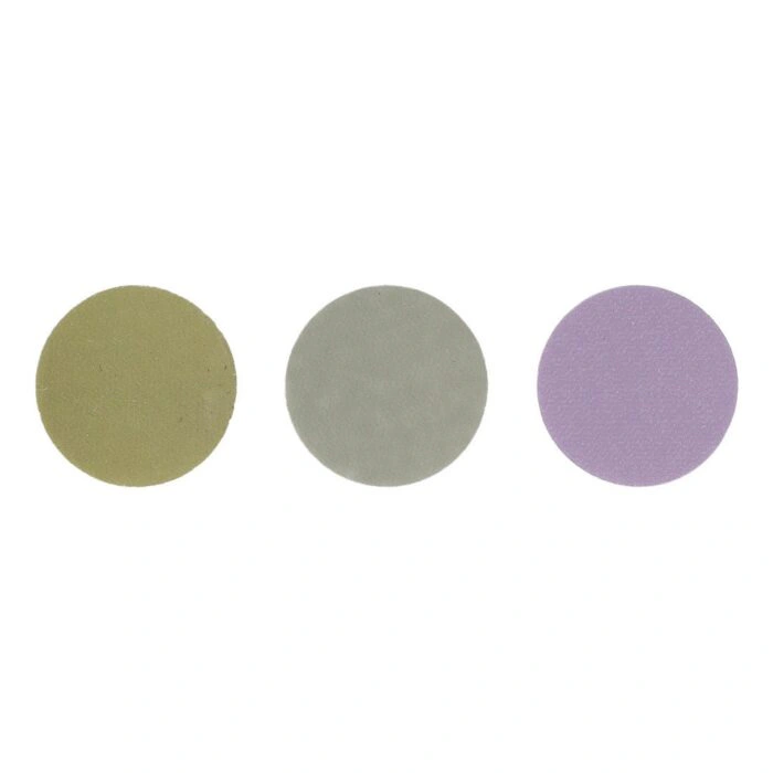 Three flat round discs in olive, gray-green, and purple on a white