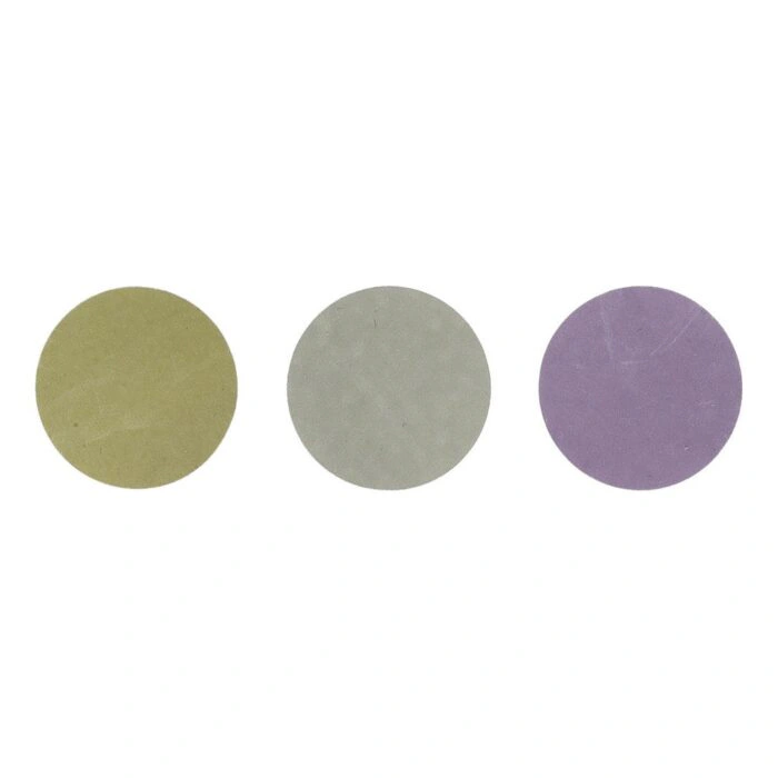 Three round abrasive discs in olive green, gray, and purple, shown side
