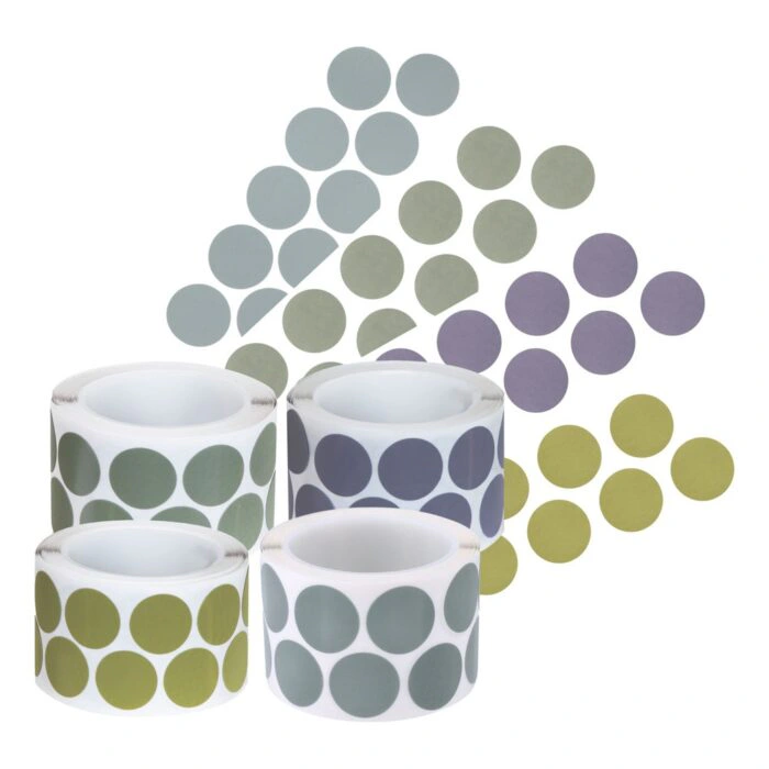 Four rolls of circular stickers in different colors, arranged together