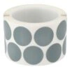 A roll of small round bluish-gray discs on a white background, shown