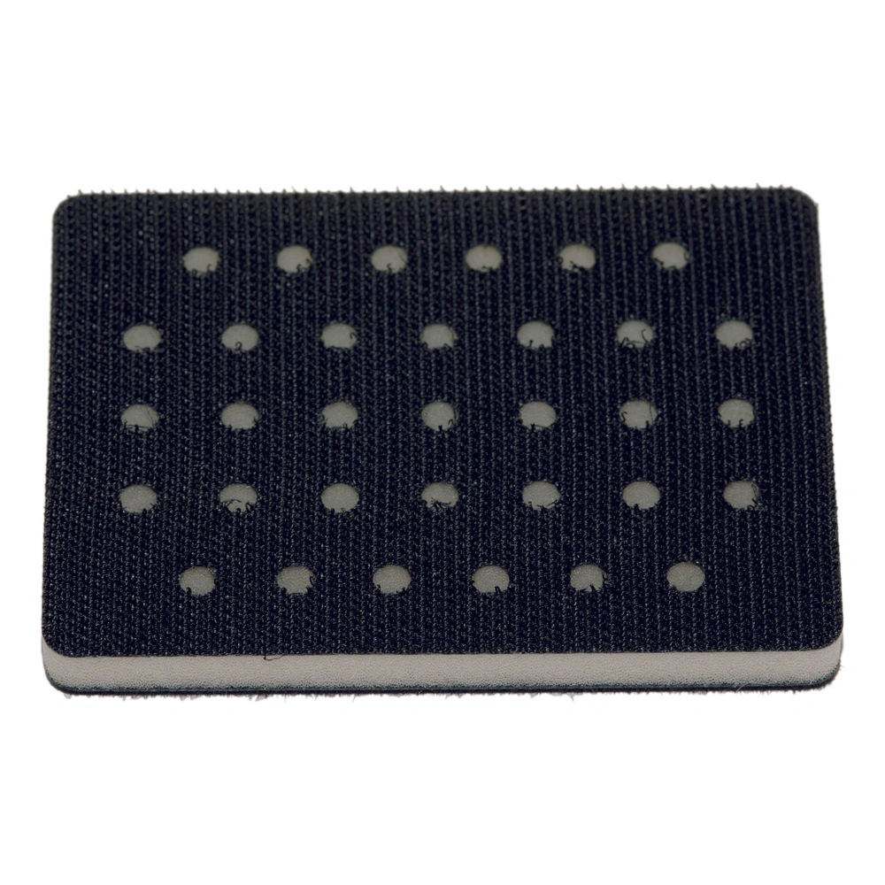 Black rectangular interface pad with rows of round holes, top view