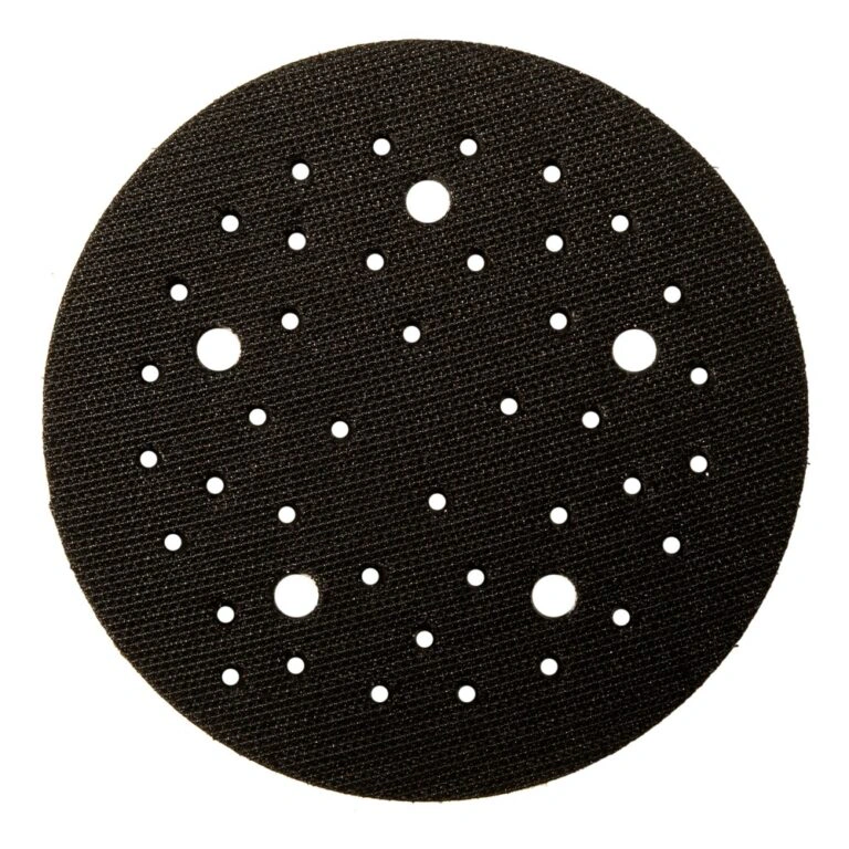 Round black interface pad with many holes of different sizes, top view