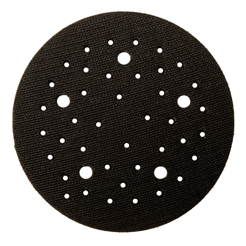 Round black interface pad with many holes of different sizes, top view