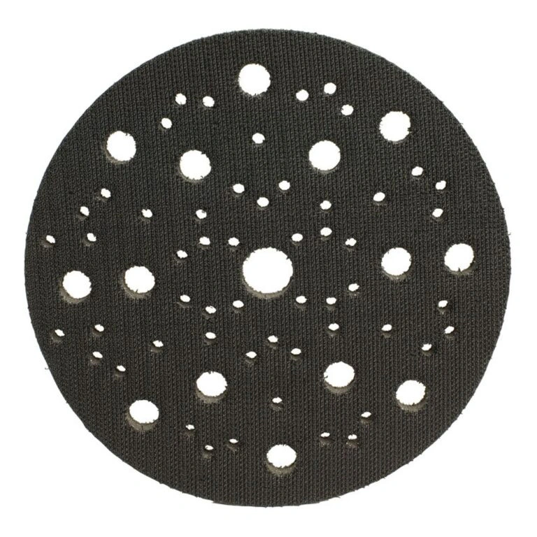 Round black interface pad with many holes in different sizes on a white