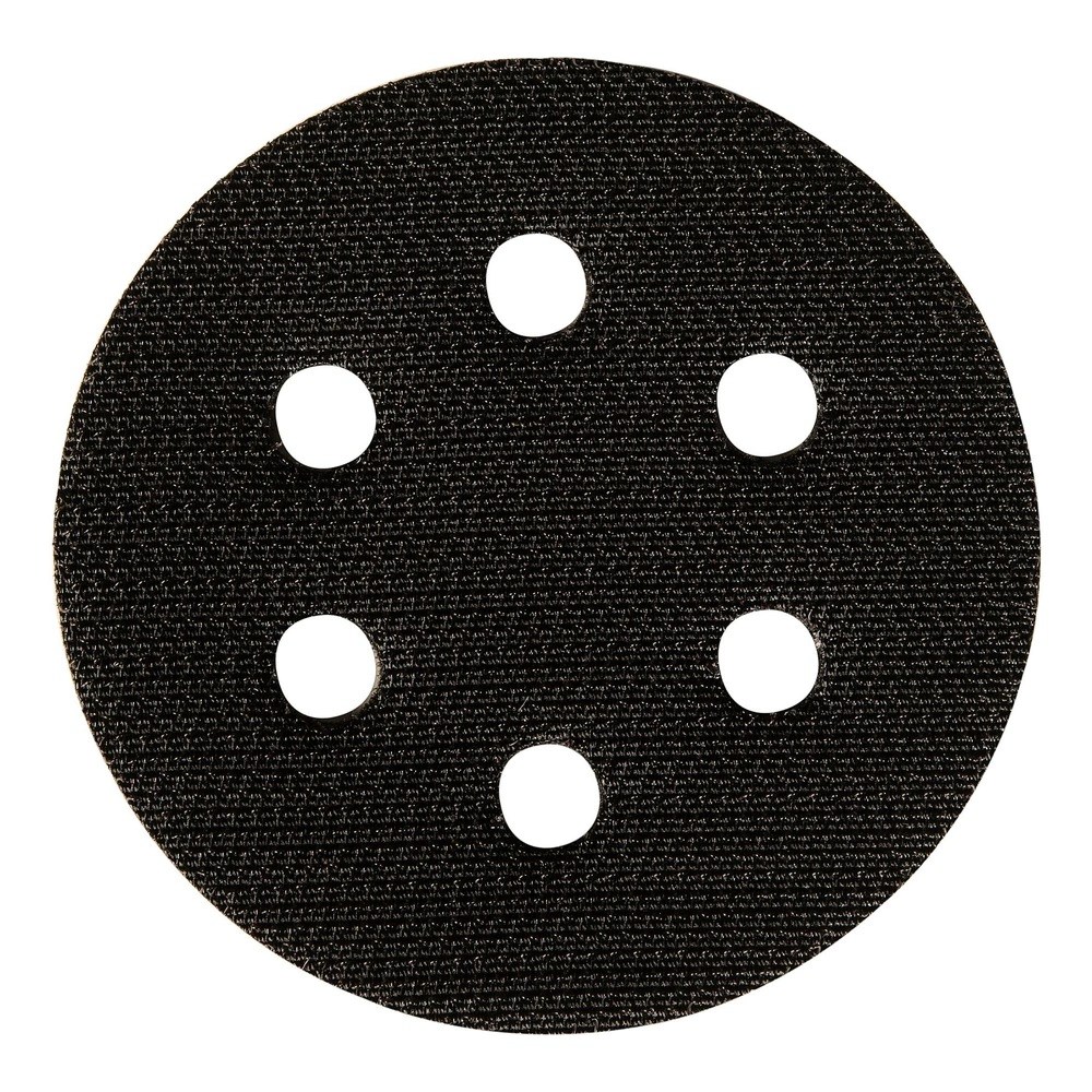 Small round black interface pad with six holes on a white background