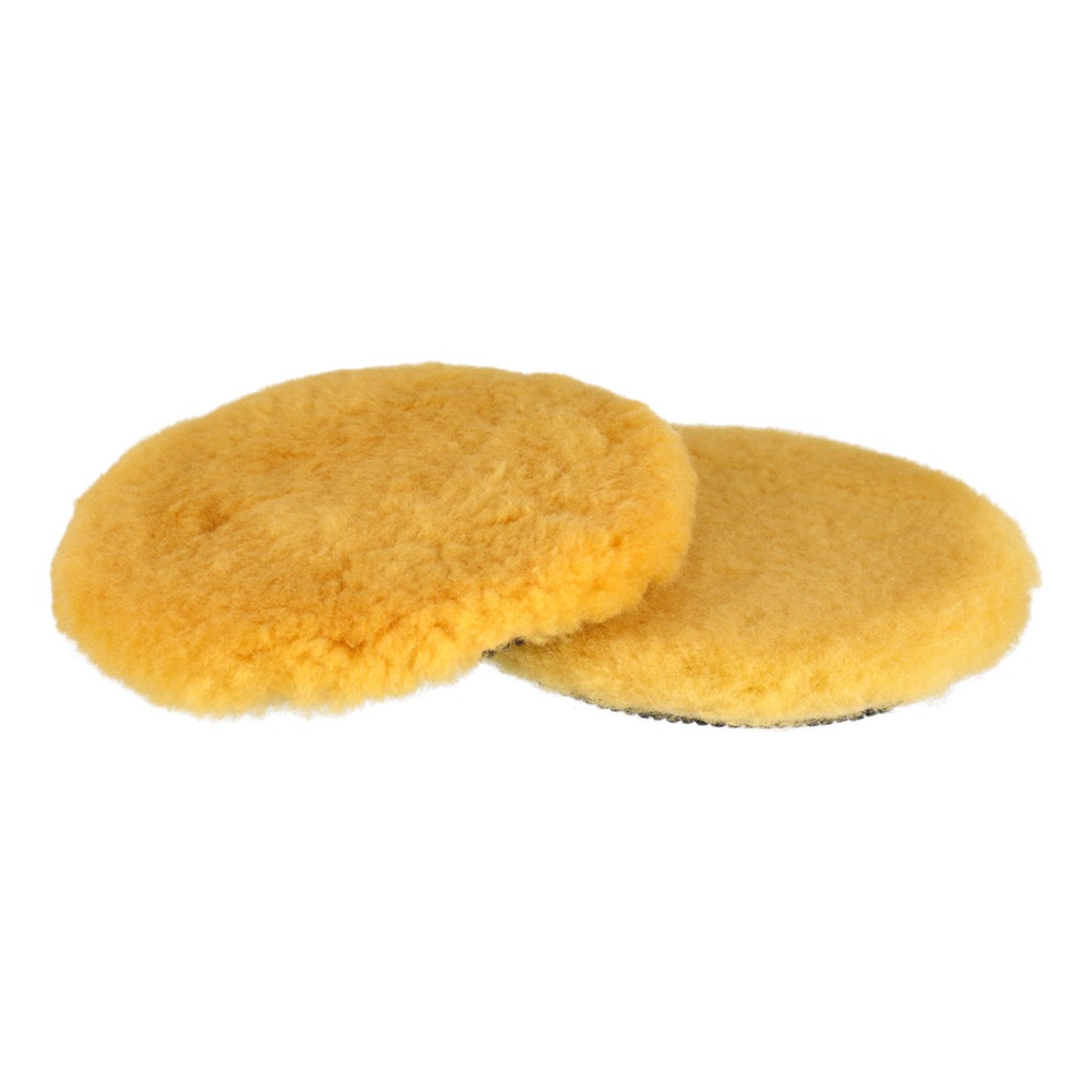 Two yellow fluffy lambswool pads overlapping on a white background
