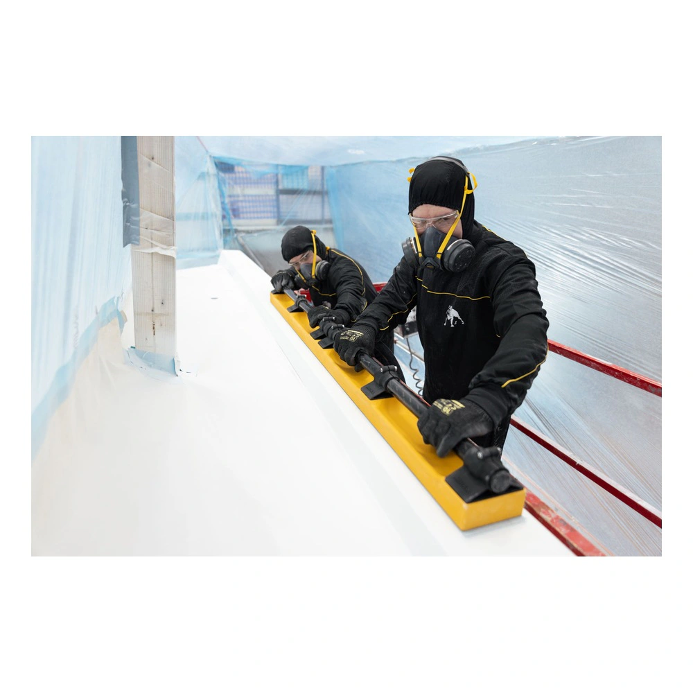 Two protected workers use a long yellow board with a tube on a white surface