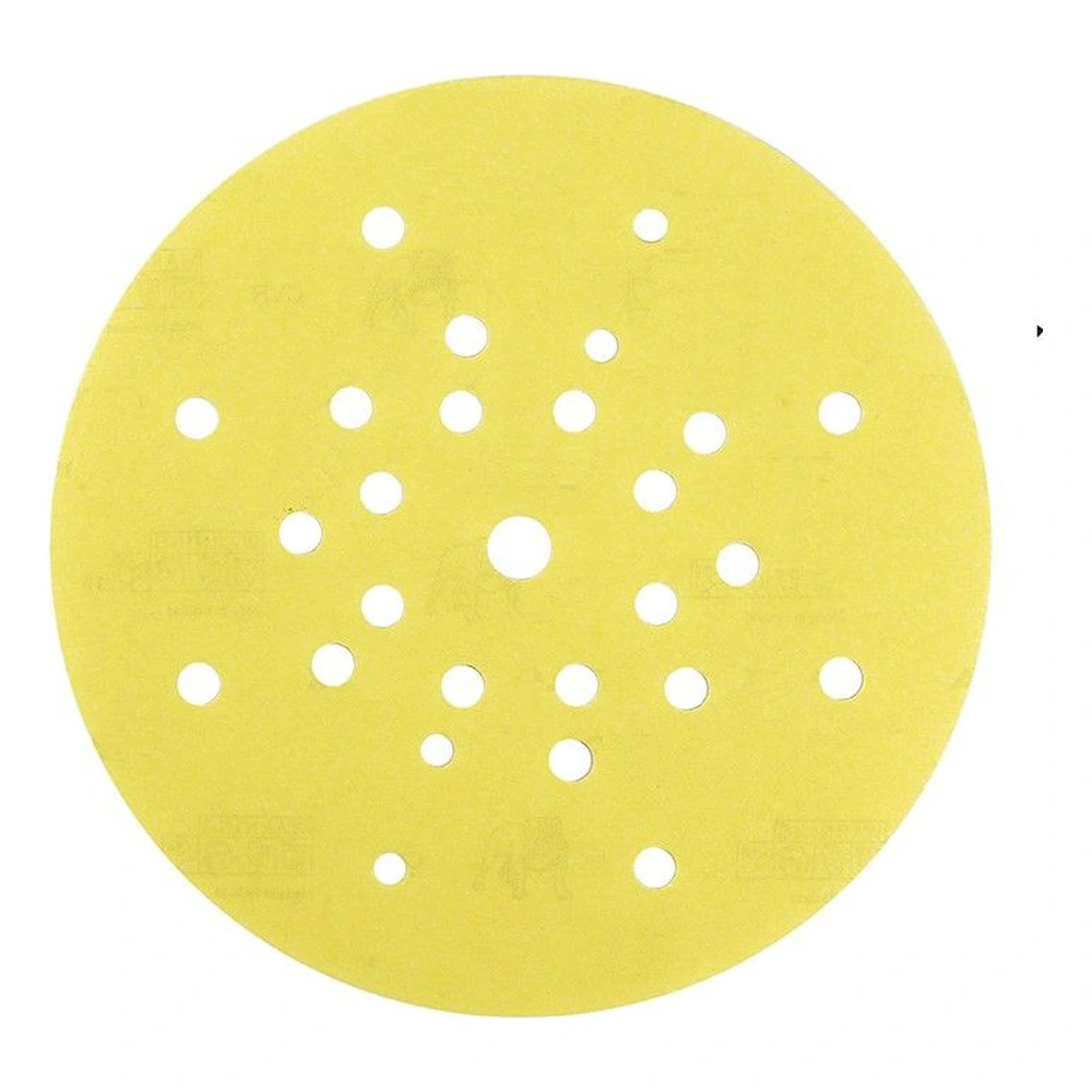 Yellow perforated sanding disc with many holes