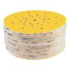 Stack of perforated yellow sanding discs
