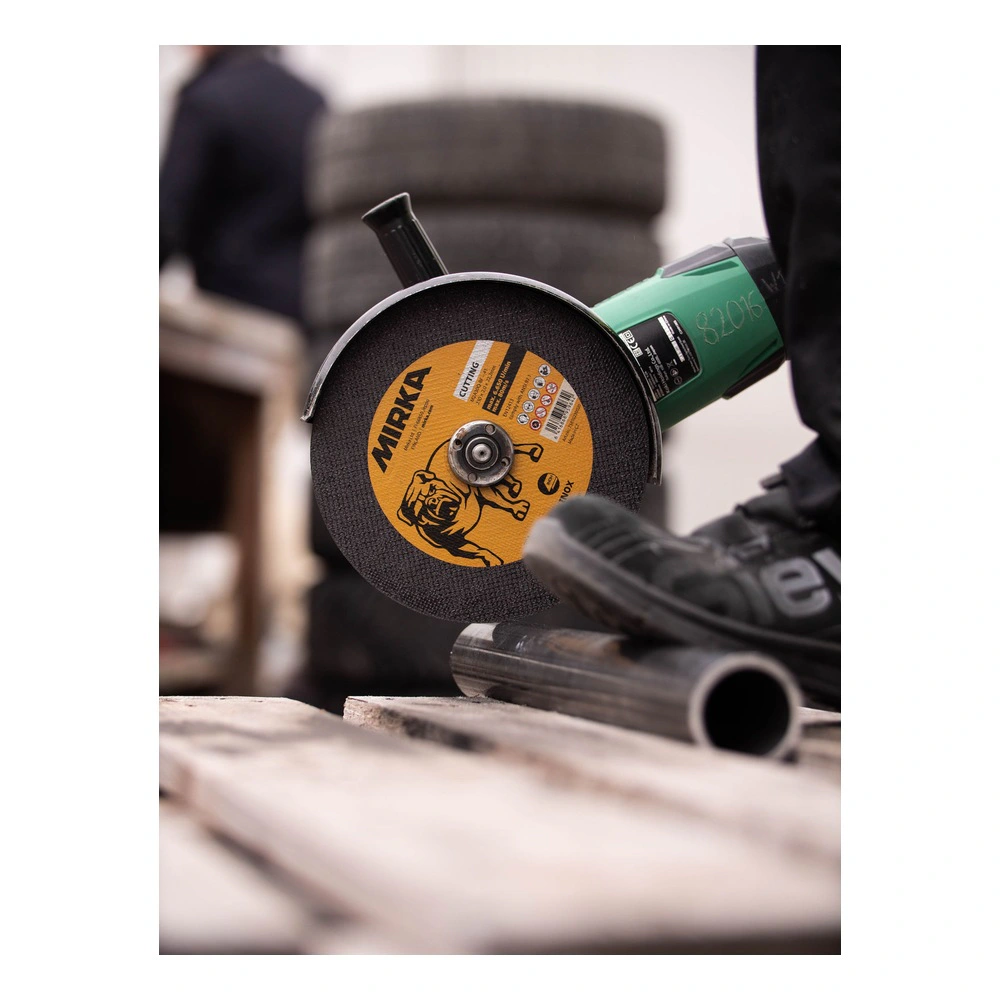Cutting disc on grinder beside a metal pipe