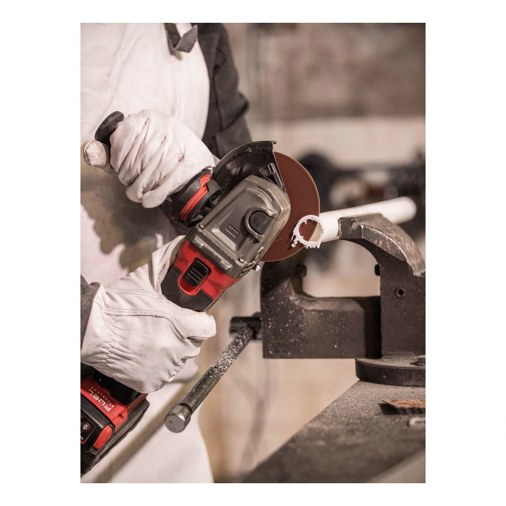 Person cutting a pipe with angle grinder