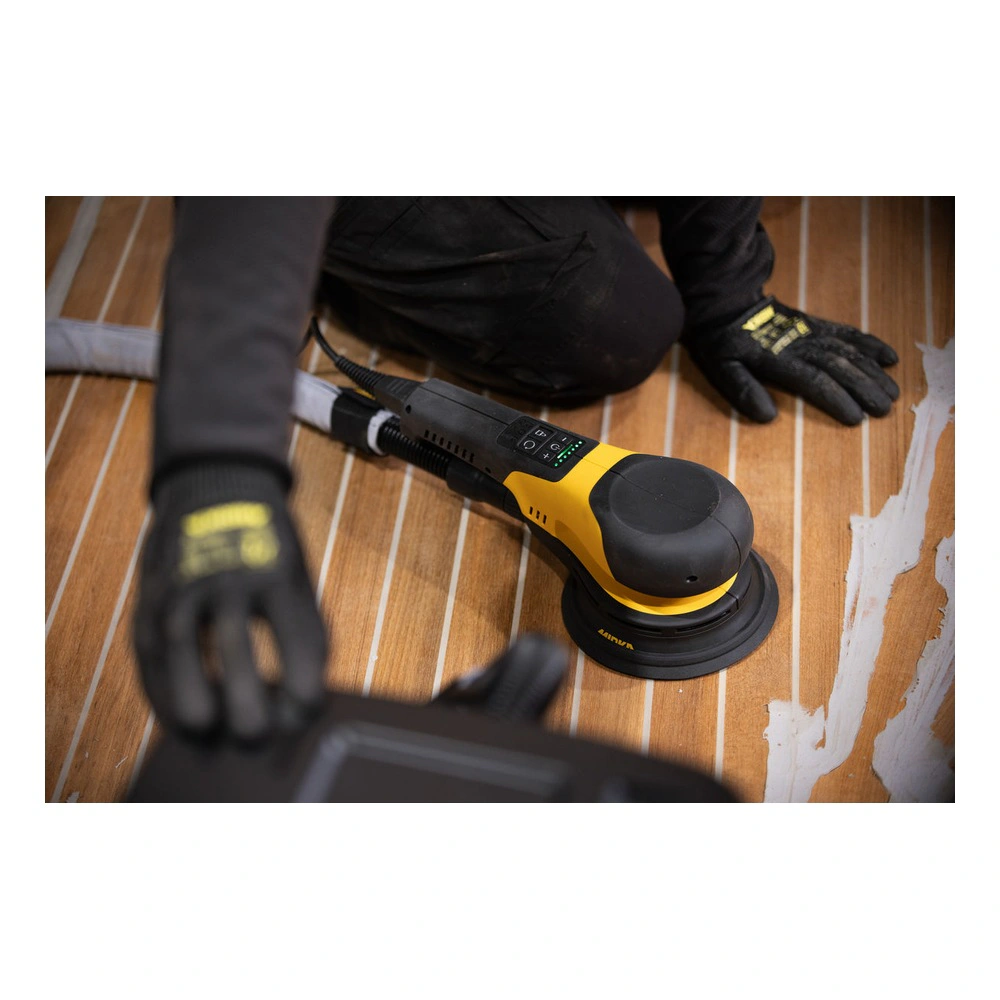 Yellow-black sander on wood floor, top view