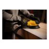 Person using a sander on a wooden surface