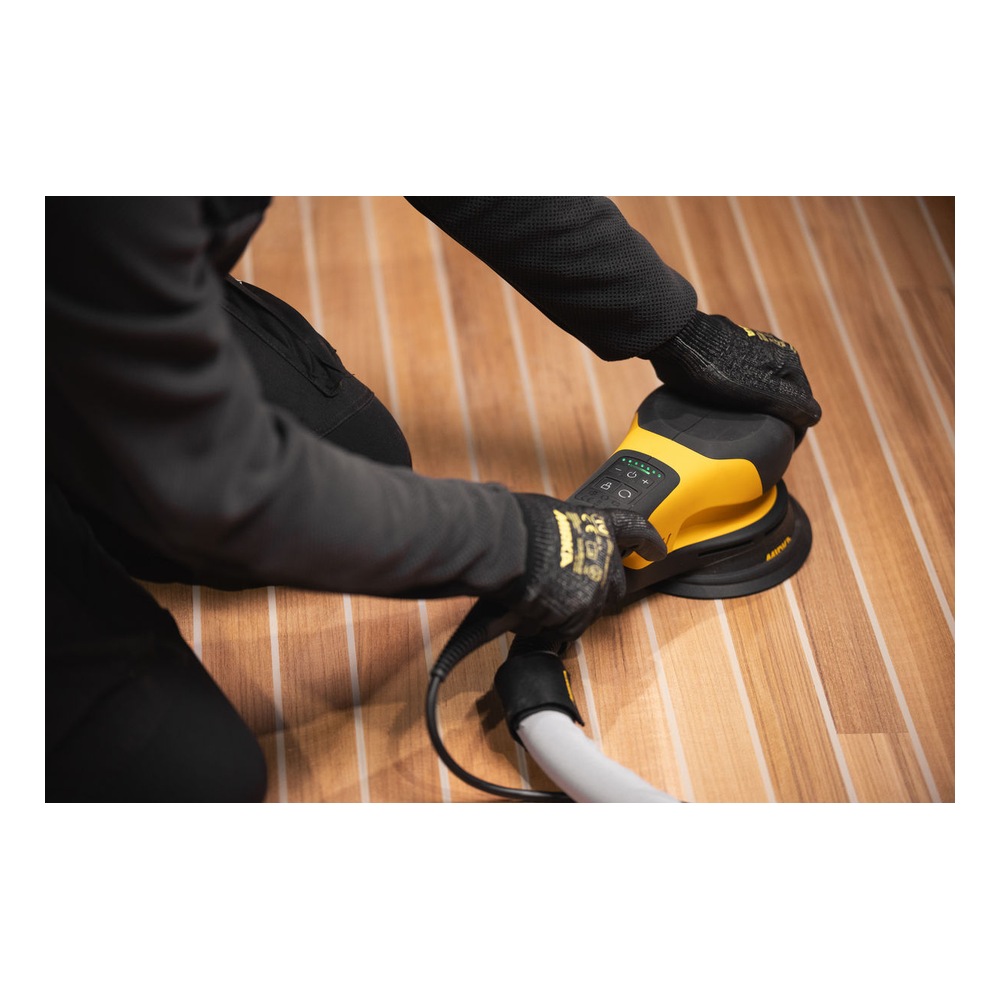 Person using a sander on a wood surface