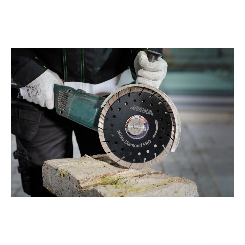 Worker cutting a masonry block with diamond disc