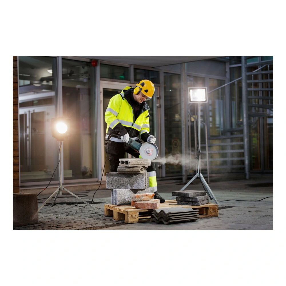 Worker cutting blocks at an outdoor site