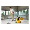 Person vacuuming with a yellow extractor