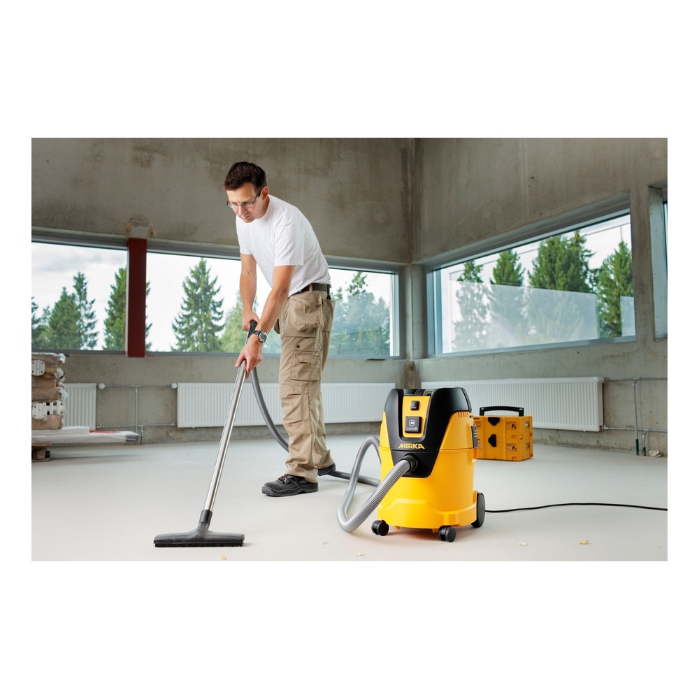 Person vacuuming with a yellow extractor
