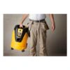 Person holding an industrial extractor beside him