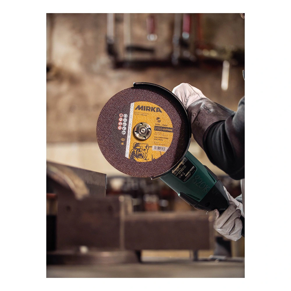 Cutting disc on angle grinder, workshop background