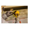 Two hands using a sander on a rough surface