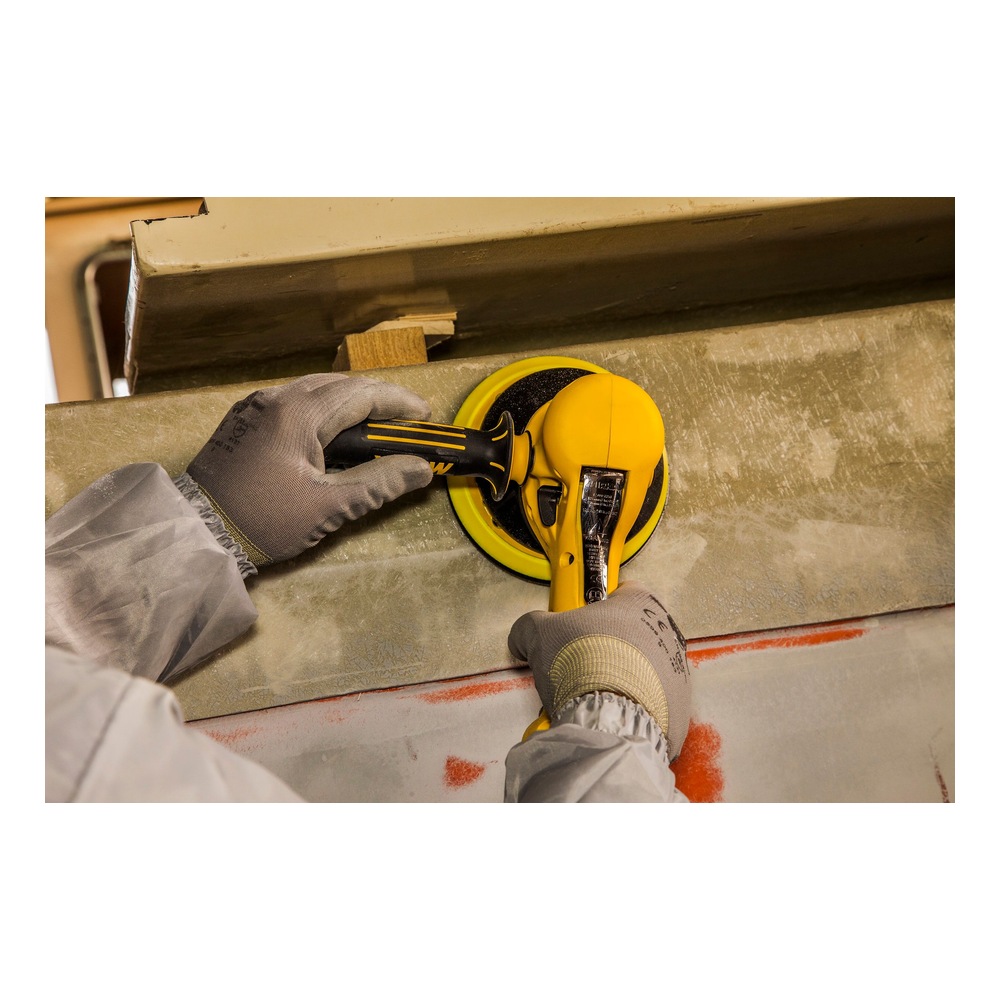 Two hands using a sander on a rough surface