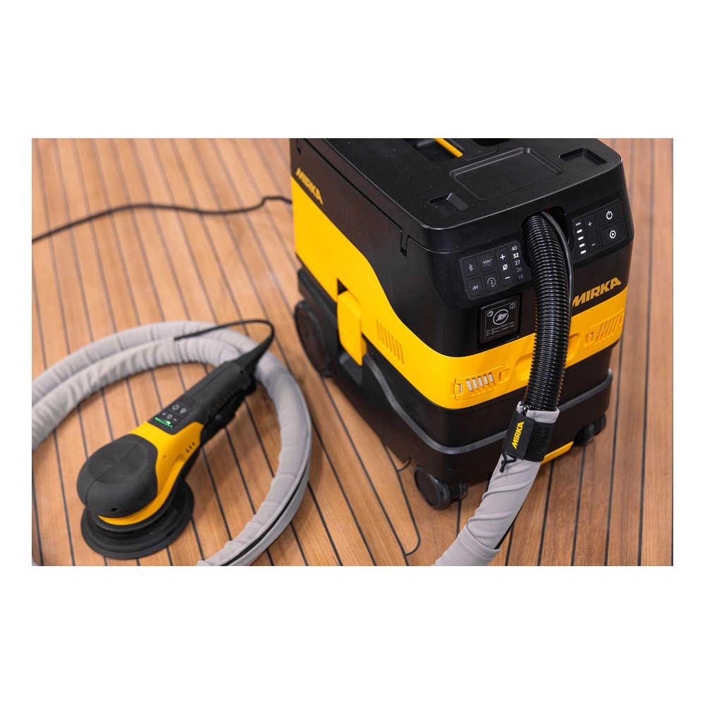 Vacuum and sander on a wood floor