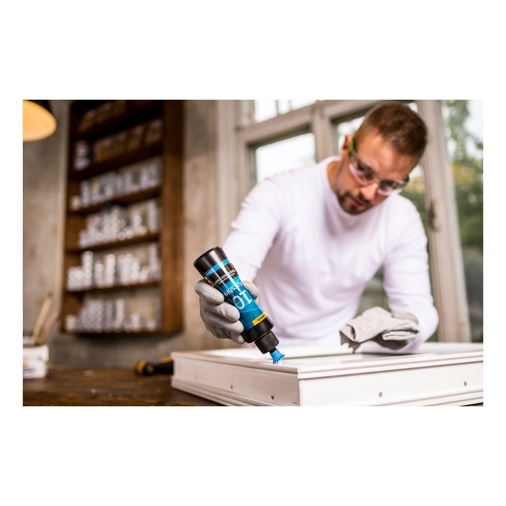 Man applies polishing compound on a white surface
