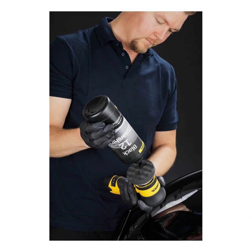 Man applying polish onto a polishing machine