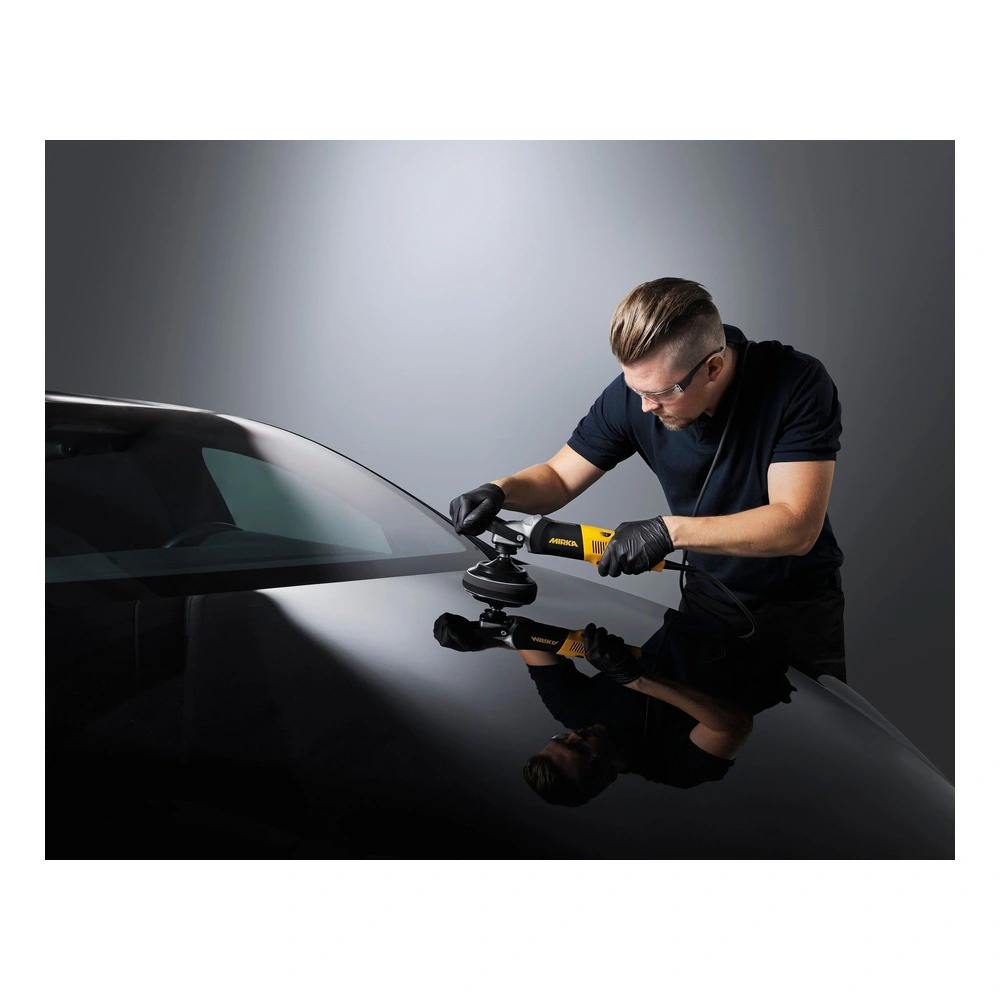 Man polishing a black car hood with machine