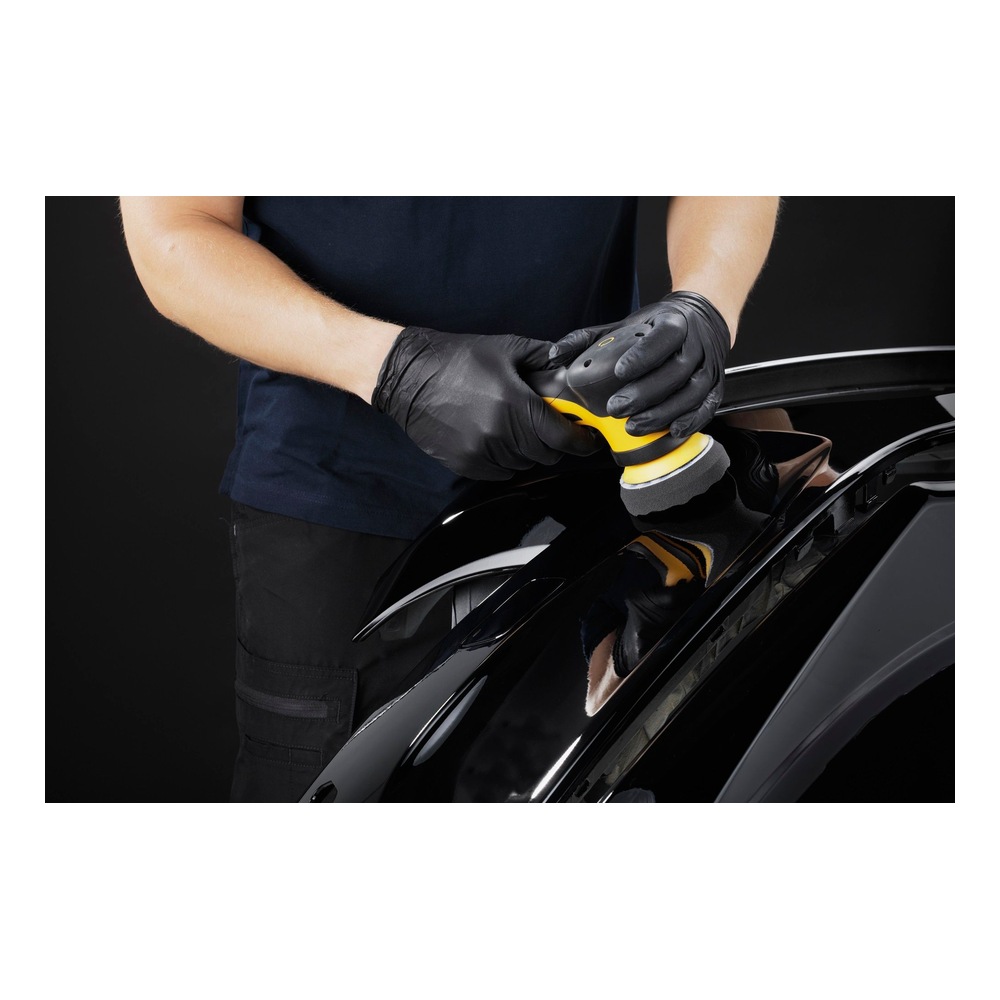 Person polishing a black car surface with hand tool