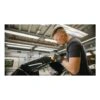 Worker polishing a black part with hand tool