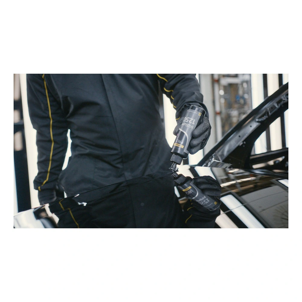 Person applies compound on glossy car panel