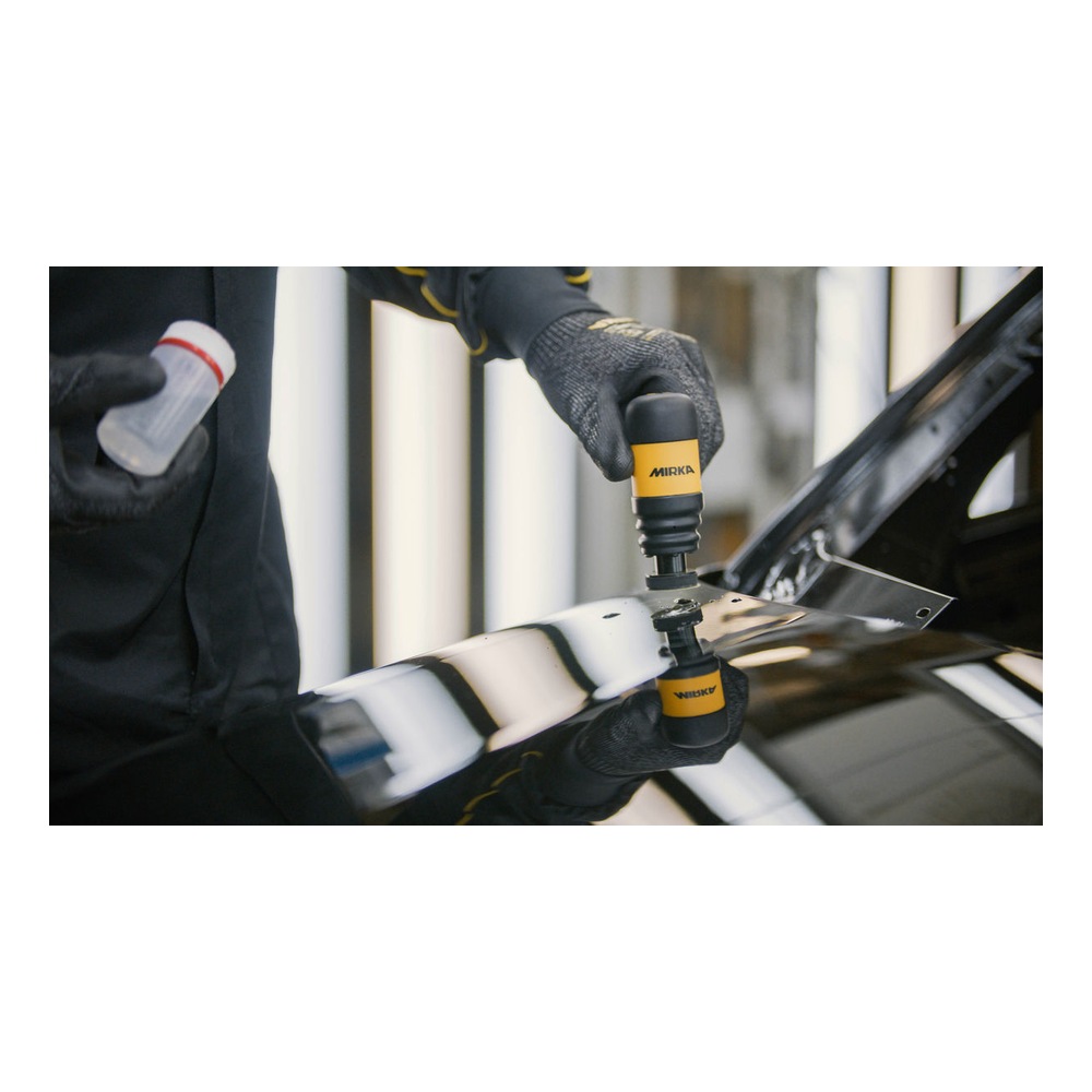 Person uses a polisher on a car panel