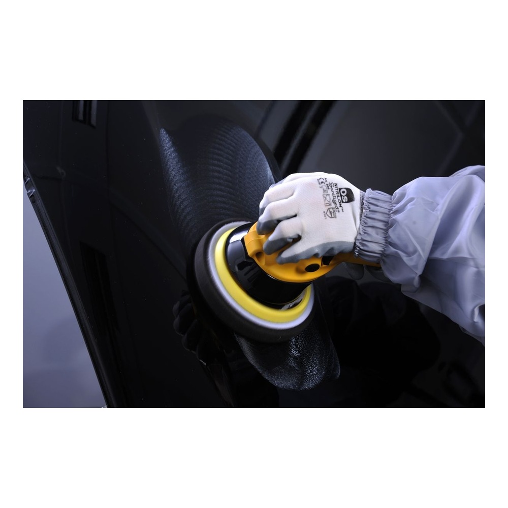 Person polishing a black surface with machine