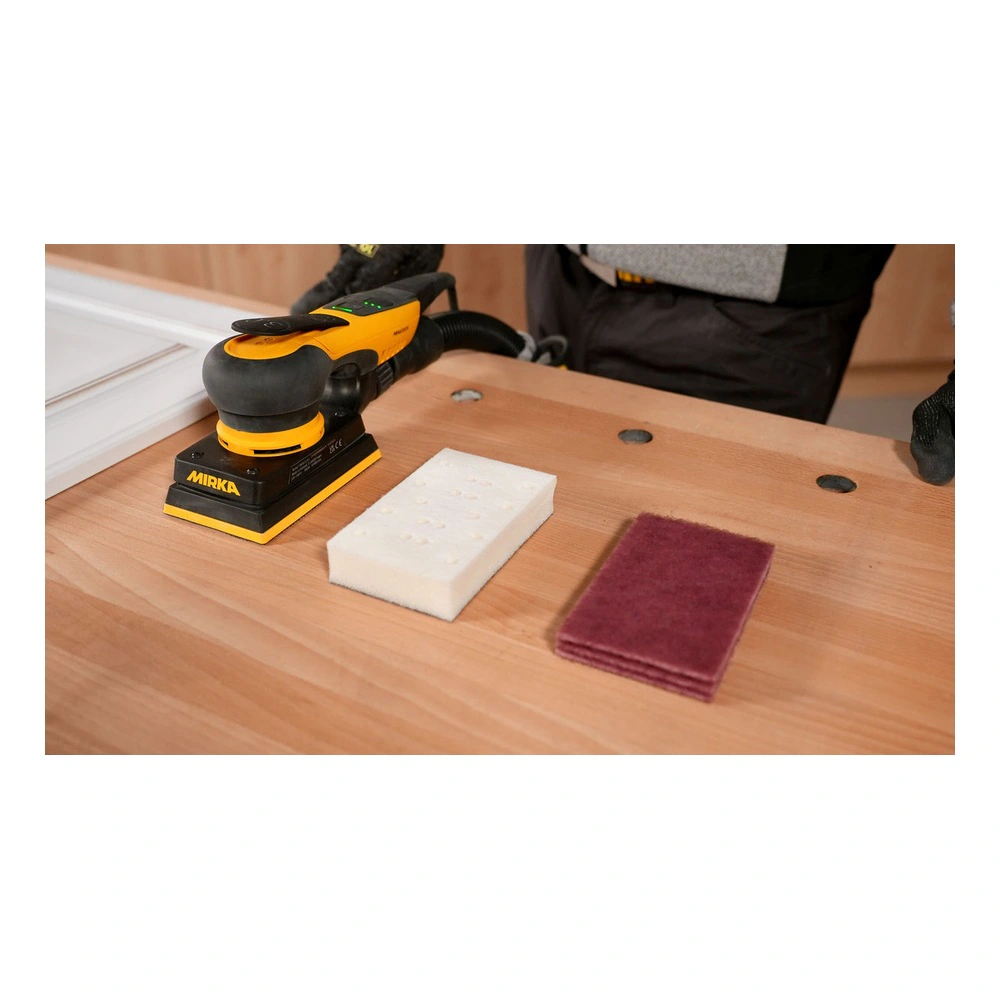 Sander, foam pad and fiber pad on table