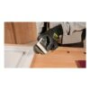 Gloved hand holding sander beside a wood panel