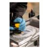 Gloved hands using polishing tool on surface