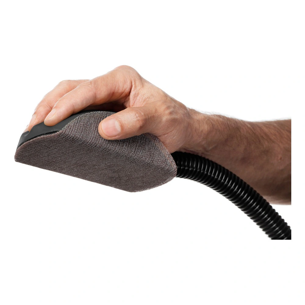 Hand holding sanding block connected to hose