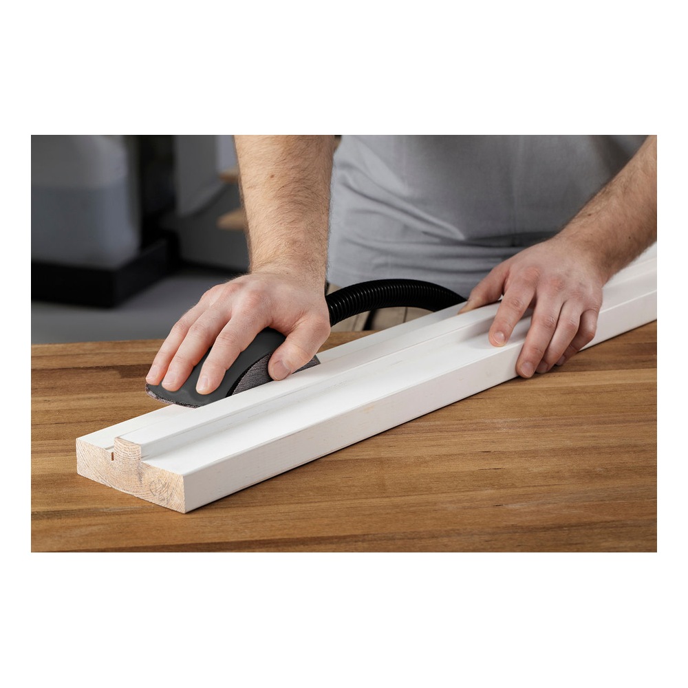 Person sanding a white wood strip on a table