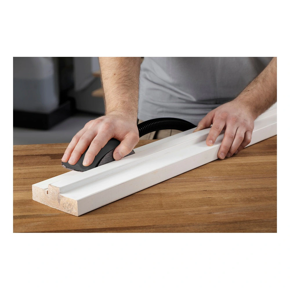 Person sanding a white wood strip on a table