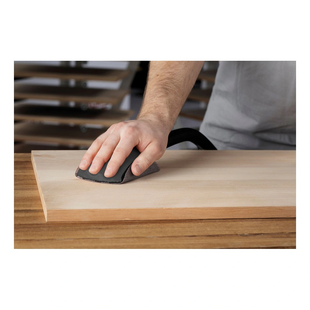 Hand sanding a flat wood board on a table