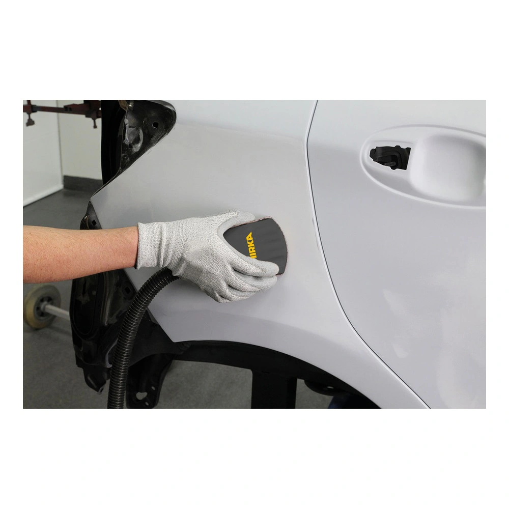 Gloved hand sanding a white car panel