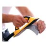 Hands hold a yellow-black sanding block with hose