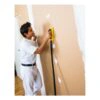 Man sanding a drywall wall with yellow block