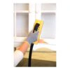 Gloved hand sanding white trim with yellow block