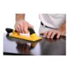 Yellow sanding block on a glossy black surface