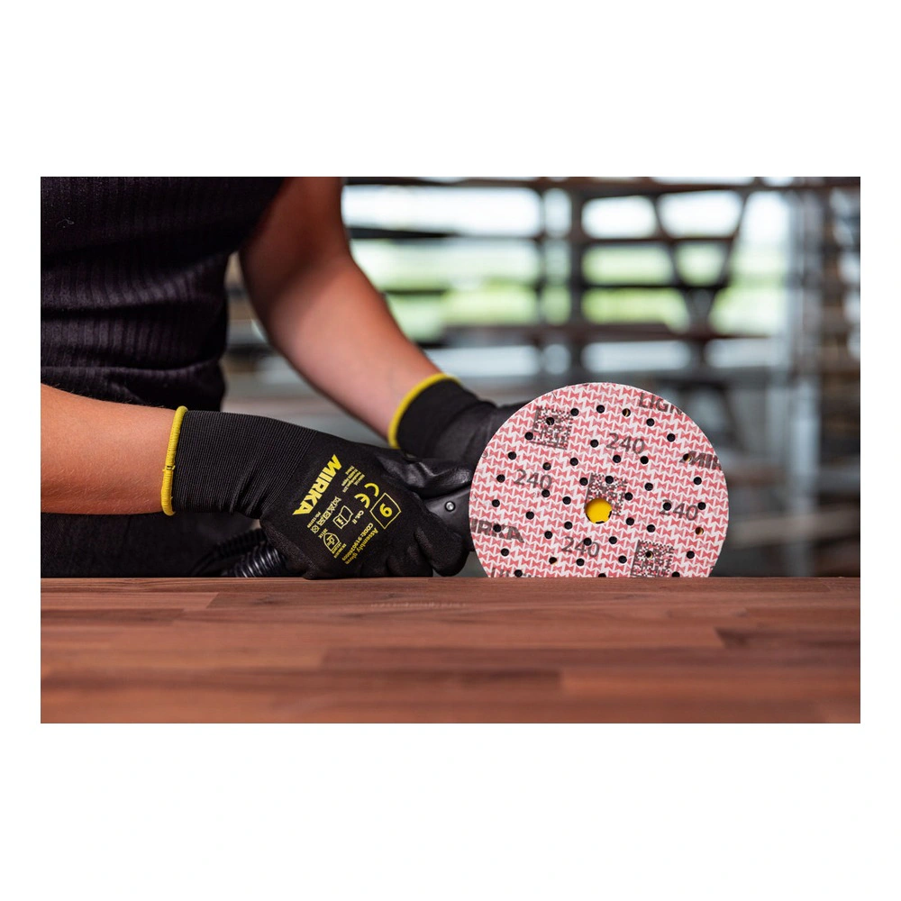 Person sanding a wood board with perforated disc